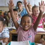 Happy children engaged in American Sign Language education.